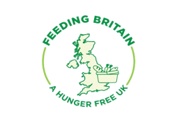 The Feeding Britain logo made up of a map of Britain in green with a shopping basket surrounded by the words: Feeding Britain, A Hunger Free UK.